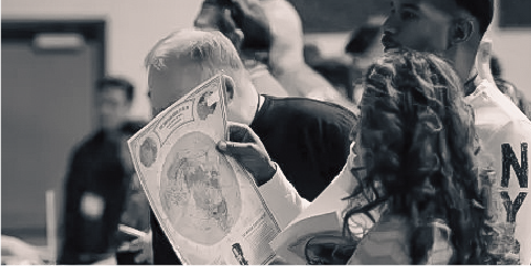 People looking at flat earth poster